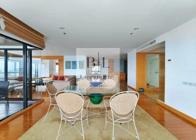 Bright and modern living-dining area with wooden flooring and natural light