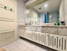 Bathroom with large vanity mirror and built-in cabinets