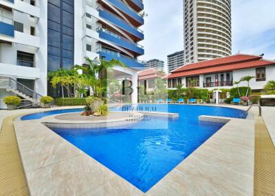 Outdoor swimming pool area with buildings in the background