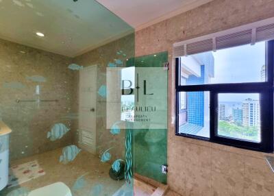 Modern bathroom with large glass shower and window view