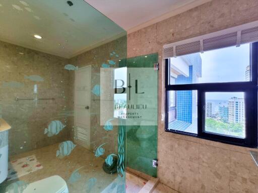 Modern bathroom with large glass shower and window view