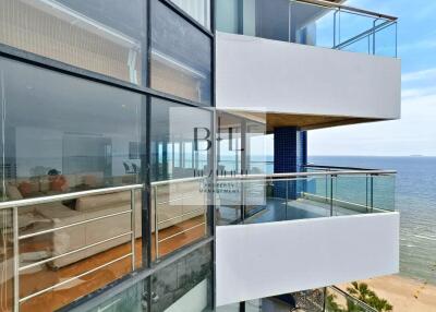 Modern beachfront building with glass balconies