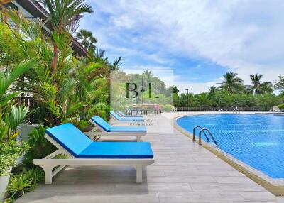 Outdoor pool area with lounge chairs