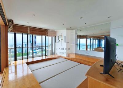 Spacious living area with large windows and city views