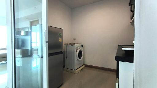 Laundry room with washing machine and refrigerator