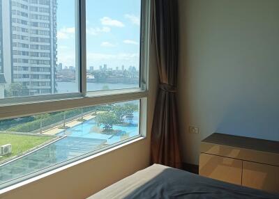 Bedroom with large window and city view