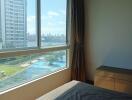 Bedroom with large window and city view