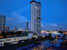 Scenic night view of a high-rise building by the river with city lights