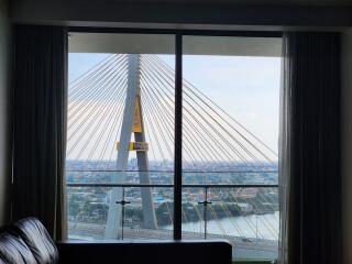 Living room with large window view of cable-stayed bridge