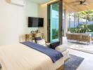 Modern bedroom with large sliding glass doors leading to a patio with a pool