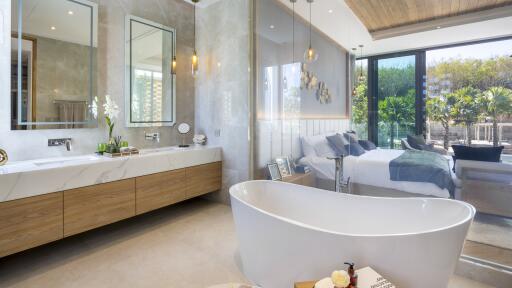 Modern bathroom with freestanding tub and view to bedroom