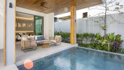 Outdoor seating area next to private pool with view into living room