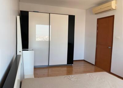 Modern bedroom with large wardrobe and air conditioning