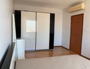 Modern bedroom with large wardrobe and air conditioning