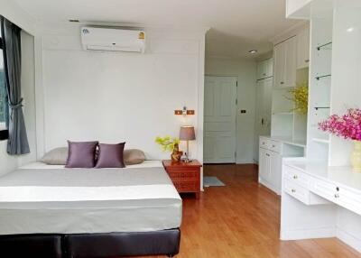 modern bedroom with bed, air conditioner, and built-in shelves