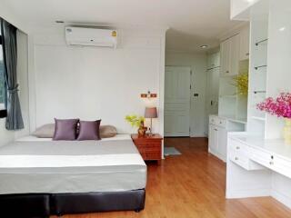 modern bedroom with bed, air conditioner, and built-in shelves