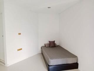 Minimalist bedroom with single bed