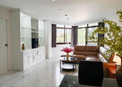 Bright and spacious living room with a brown leather sectional sofa and modern decor