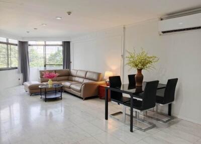 Spacious and well-lit living room with modern furnishings