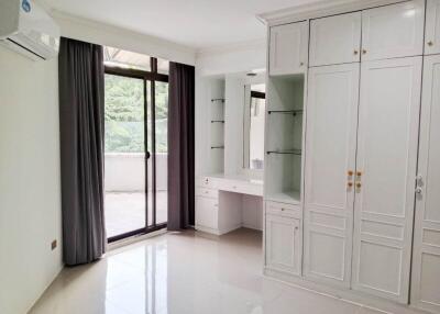 Bright bedroom with large window and built-in wardrobe