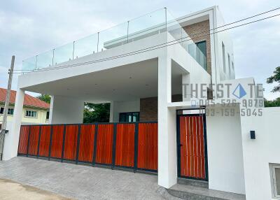 Modern two-story building with a red gate