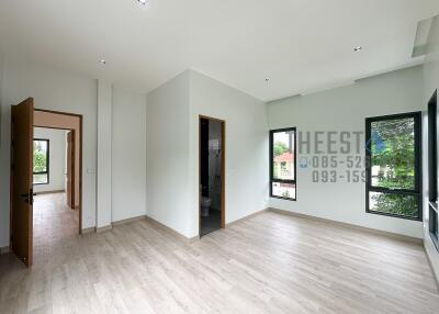 Bright and spacious living area with large windows and hardwood floors