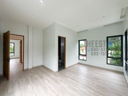 Bright and spacious living area with large windows and hardwood floors