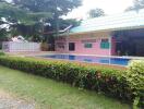 Outdoor swimming pool area with a surrounding garden