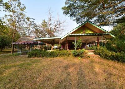 Spacious outdoor view with green surroundings and covered structures