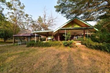 Spacious outdoor view with green surroundings and covered structures