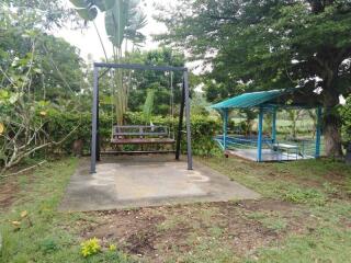 Outdoor garden area with swing and gazebo