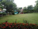 View of a colorful house in a spacious garden