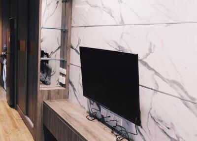 Modern living room with mounted TV and marble wall