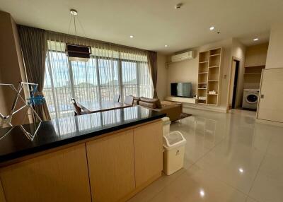 Living area with a view, modern furnishings, and a connected kitchen