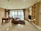 Modern living room with dining area providing ample natural light