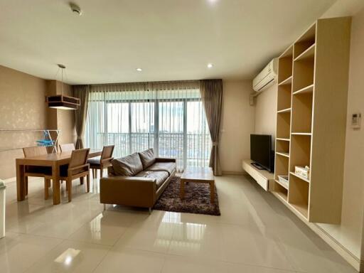 Modern living room with dining area providing ample natural light