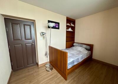 Simple bedroom with wooden furnishings and natural light