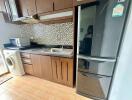 Modern kitchen with wooden cabinets, tiled backsplash, and appliances