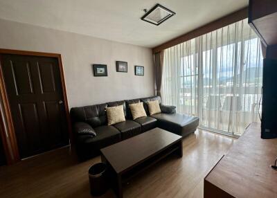 Modern living room with large window and ample natural light