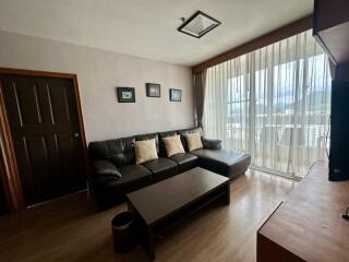 Modern living room with large window and ample natural light