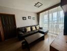 Modern living room with large window and ample natural light