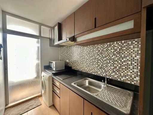 Modern kitchen with mosaic backsplash and integrated appliances