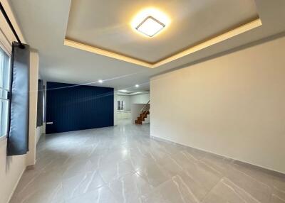 Spacious living room with tiled flooring and recessed lighting