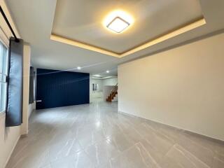 Spacious living room with tiled flooring and recessed lighting