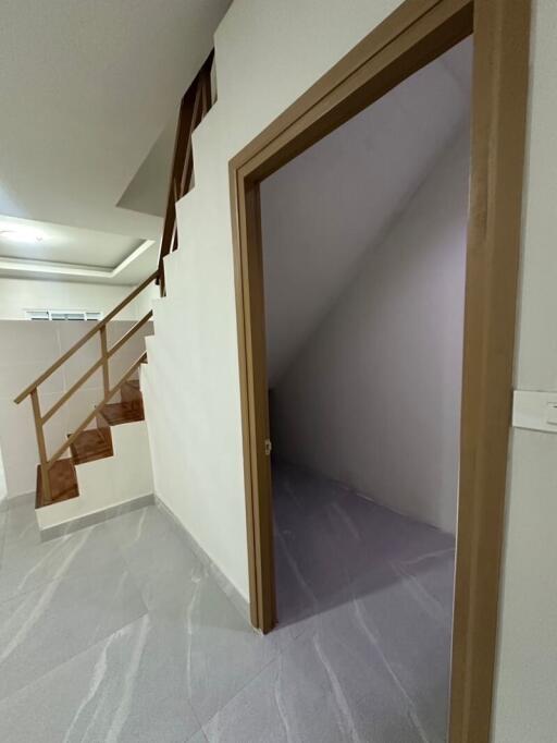 Stairs and small storage area in hallway