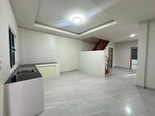 Modern kitchen with staircase in a residential property