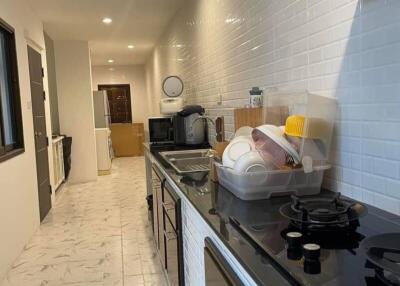 Modern kitchen with black countertops and white tiles