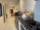 Modern kitchen with black countertops and white tiles