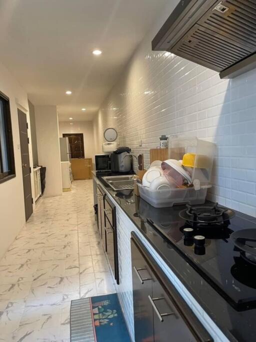 Modern kitchen with black countertops and white tiles