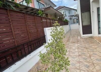 Outdoor area with tiled pathway and greenery